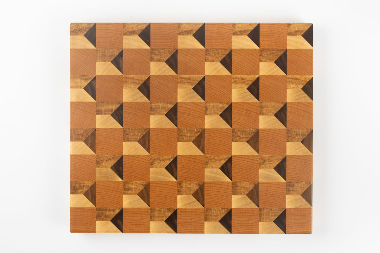 Vue de dessus de la planche à découper Cube, design cubique trompe-l’œil en relief en bois de bout multi-essences, fabrication artisanale française haut de gamme.