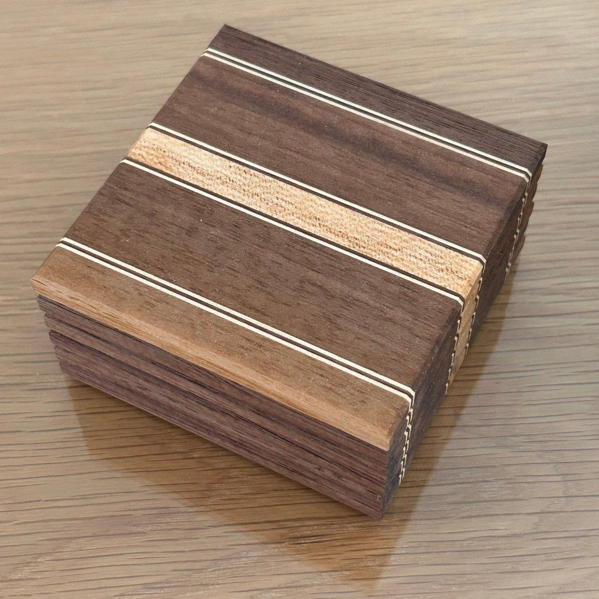 Sous-verres en bois artisanal avec design à rayures fines noyer, érable, élégants et modernes.